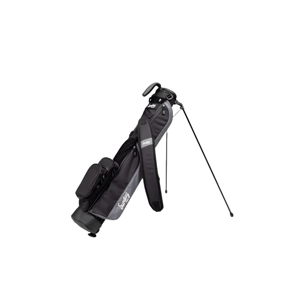 A black golf bag with a stand system, shoulder strap, and multiple pockets, designed for carrying golf clubs and accessories.