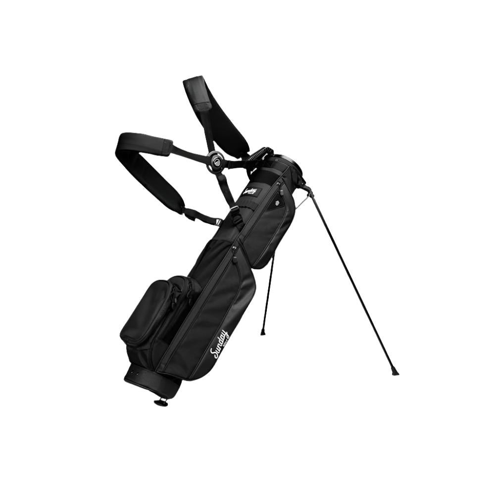 A black golf bag with a stand system, multiple pockets, and a double strap.