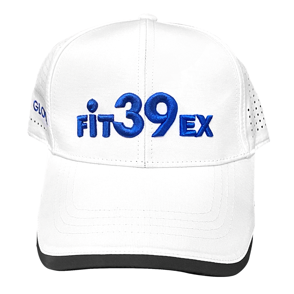 A white golf cap with the Fit39 logo in blue, featuring airholes on the sides and an adjustable Velcro strap at the back.