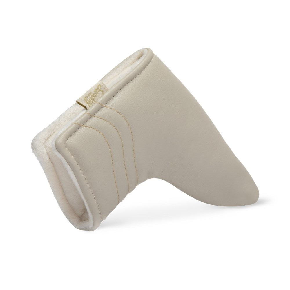 A beige vegan leather golf putter headcover with a magnetic closure.