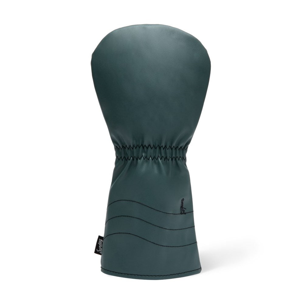A green vegan leather fairway wood headcover with a geometric design and a black label with text on the lower right side.