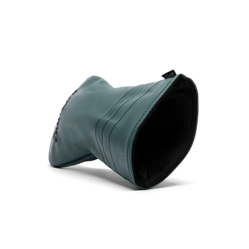 A green vegan leather fairway wood headcover with a geometric design and a black label with text on the lower right side.