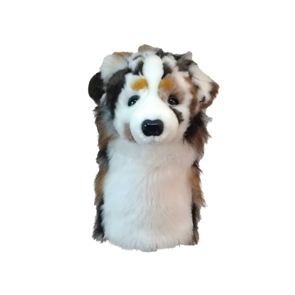 A synthetic golf club headcover designed to resemble a dog's head, with black, brown, and white colors.