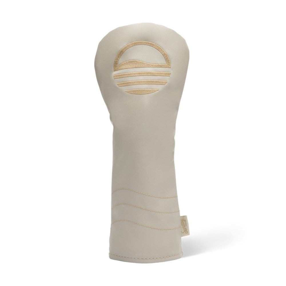 A beige fairway wood golf club headcover made of vegan leather with a sun design.
