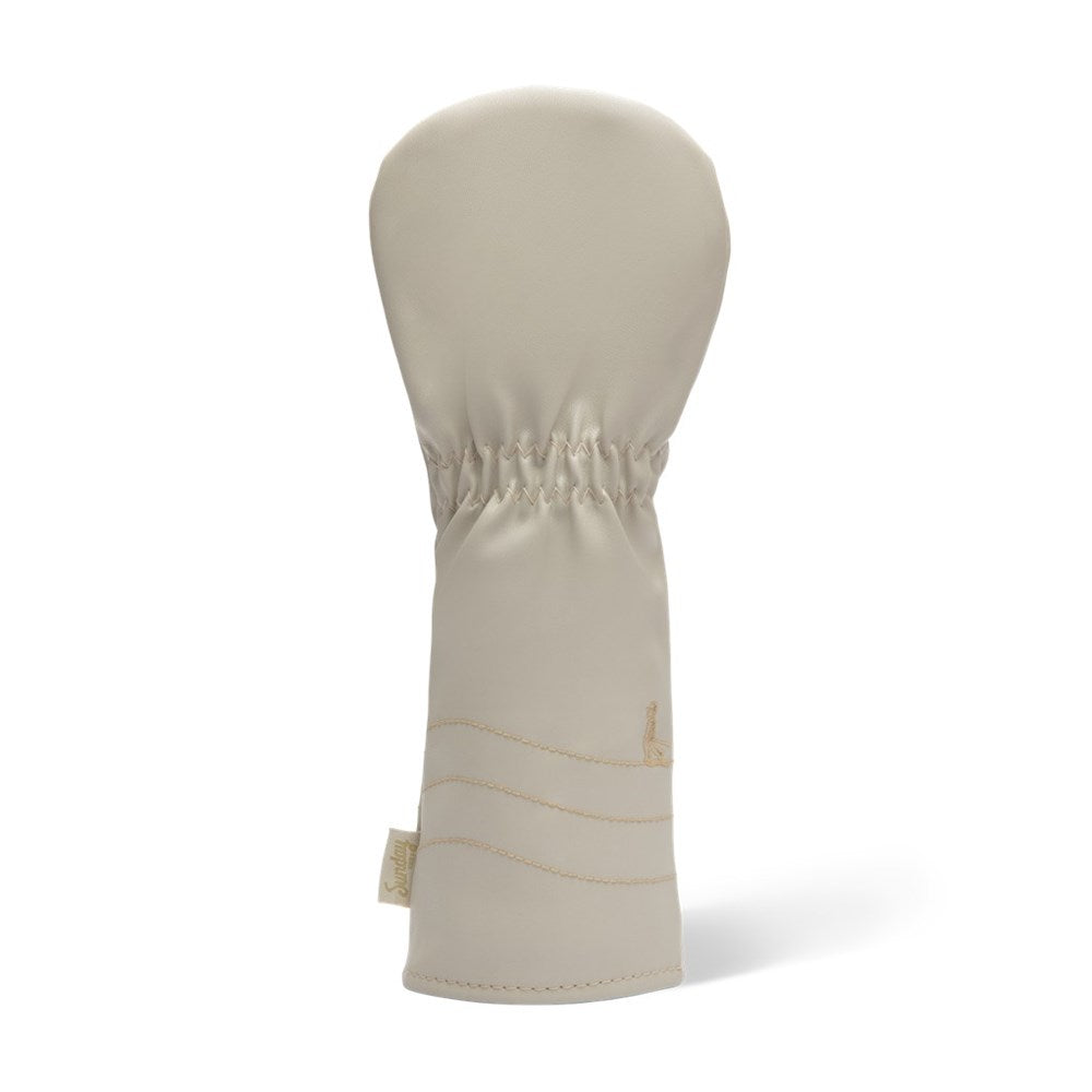 A beige fairway wood golf club headcover made of vegan leather with a sun design.
