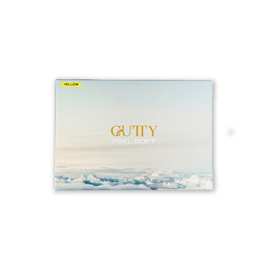 A pack of GUTTY golf balls in white and yellow colors with the brand name and the slogan 'Feel Soft' printed on the packaging against a background image of a cloudy sky.