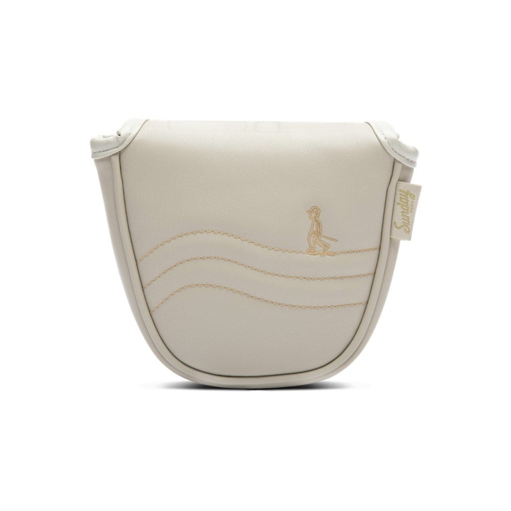 A beige mallet putter headcover made of vegan leather with a embroidered design and a magnetic closure.