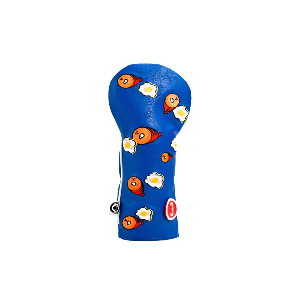 A blue golf fairway headcover with a pattern of cartoon eggs and bacon.