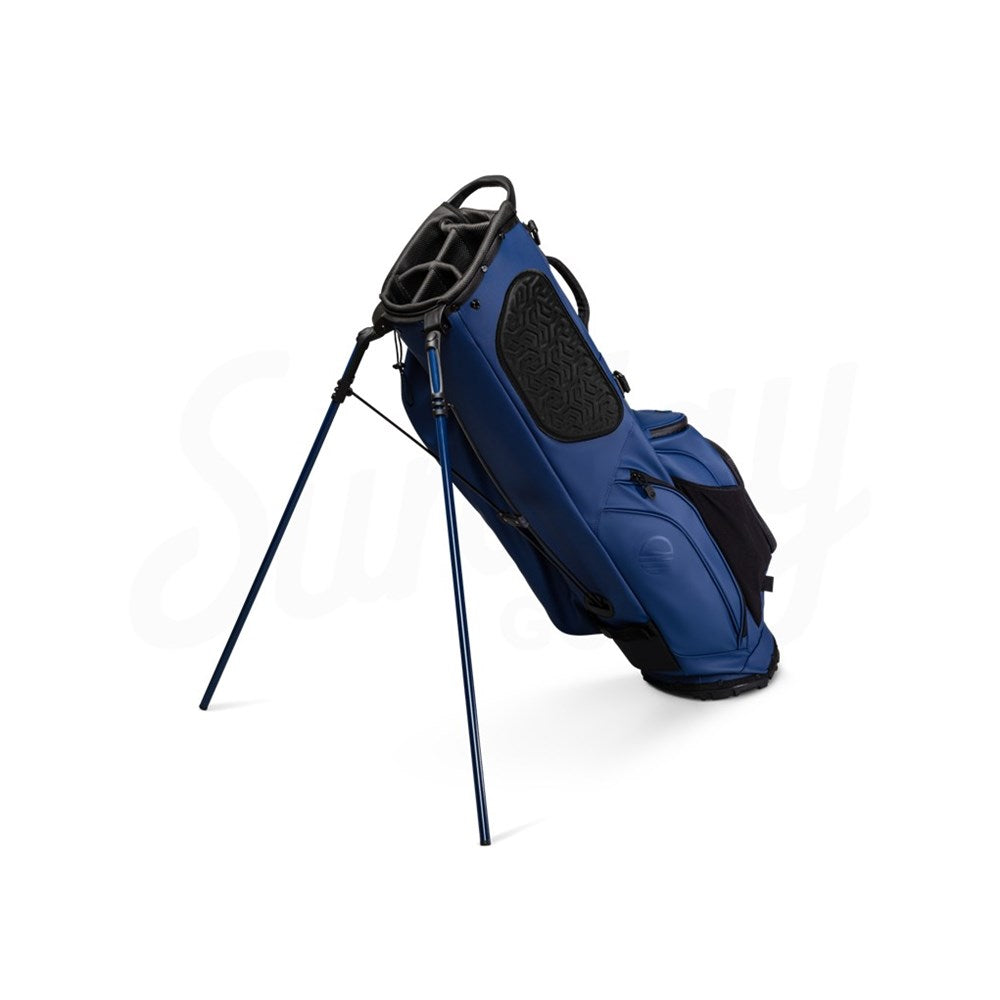 A navy blue golf bag with a stand, multiple pockets, and a backpack-style strap system.