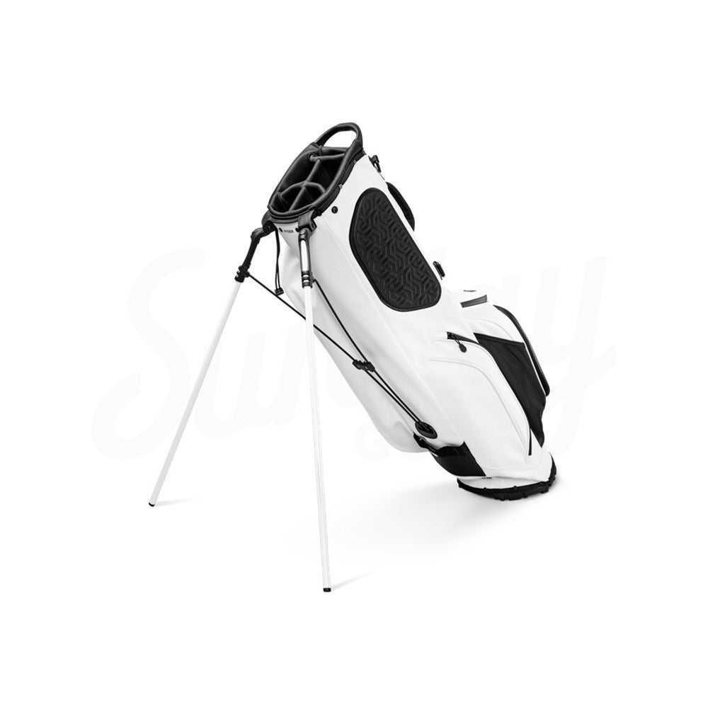 A white Sunday Golf stand bag made of vegan leather, featuring multiple pockets and a full-length divider, displayed on a stand.