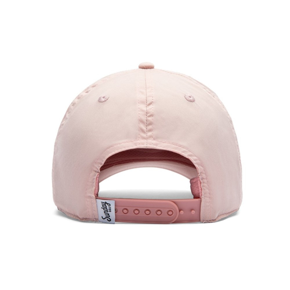 A pink coloured snapback with a tag Sunday Golf