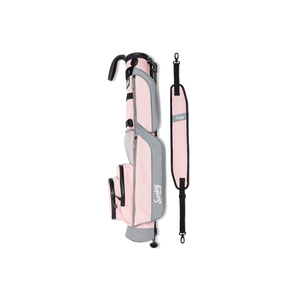 A pink and gray Sunday Golf range/green side golf bag with a detachable stand, showing the front view with multiple pockets and a logo.