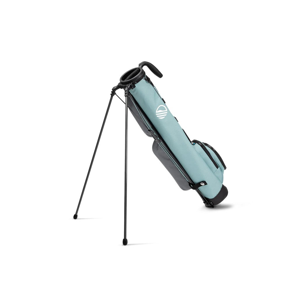 A blue and black golf bag with a stand mechanism deployed, set against a white background.
