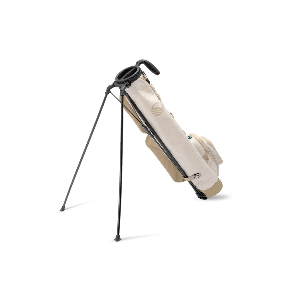 A beige golf bag with a stand, featuring multiple pockets and a shoulder strap.