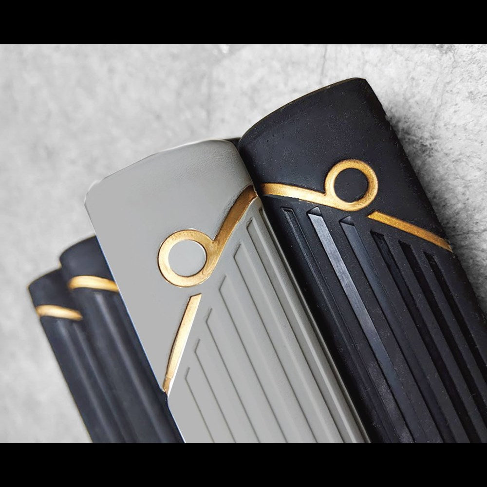 A close-up view of a putter grip with a gray and black color scheme and gold accents.