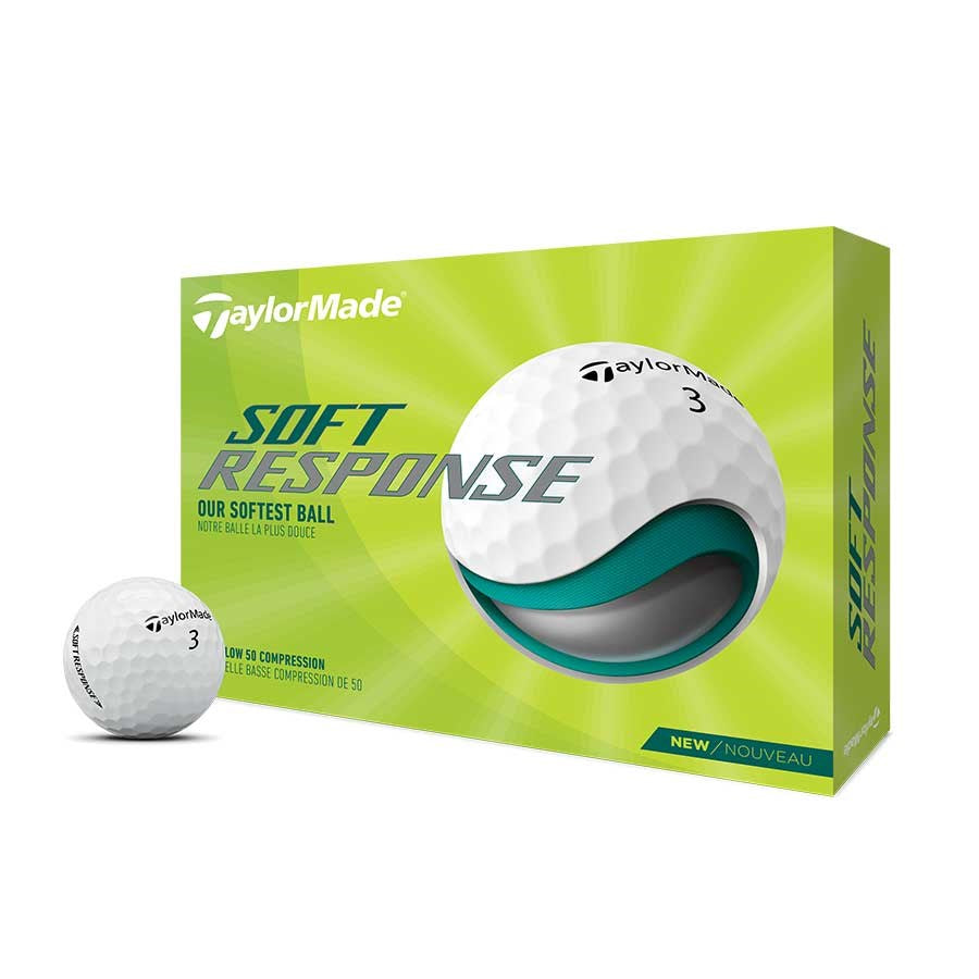 Packaging box of TaylorMade Soft Response golf ball with one golf ball visible in front of the box. The box is predominantly green with images of the golf ball and text detailing the product features.